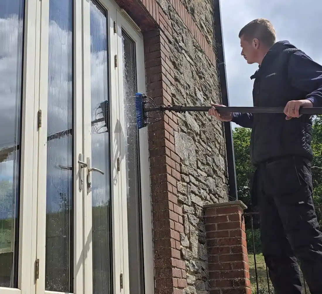 Pure water-fed pole system being used to clean upstairs windows